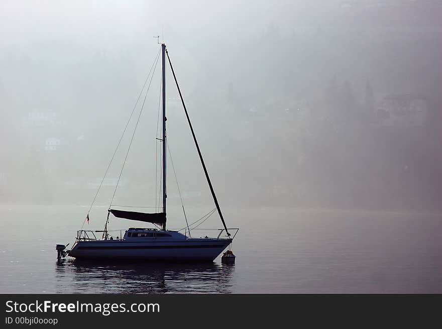 Little boat in backlight, italian lake. Little boat in backlight, italian lake.