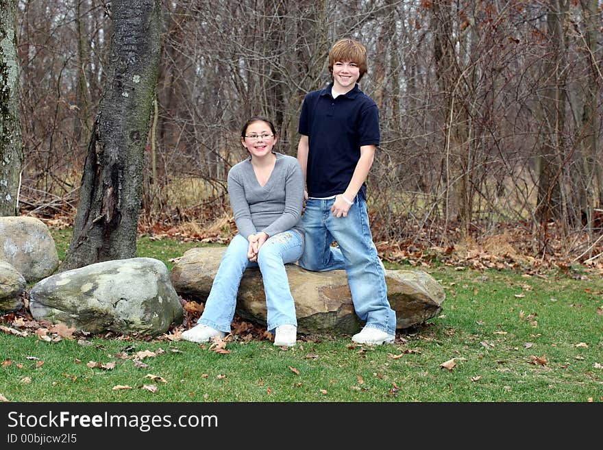 Young happy teen siblings in park like setting. Young happy teen siblings in park like setting.