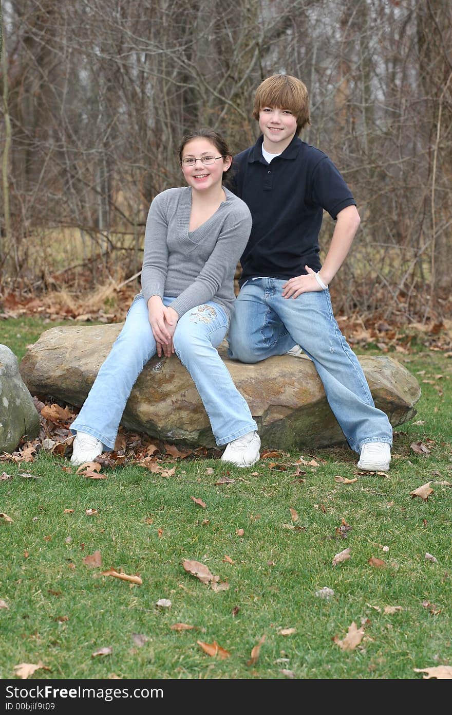 Young happy teen siblings in park like setting. Young happy teen siblings in park like setting.