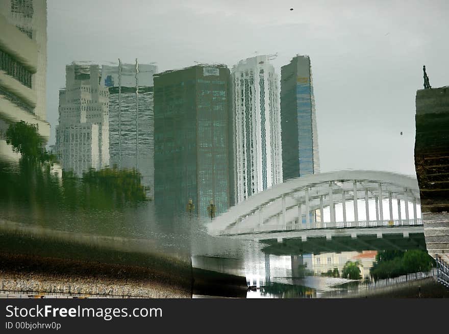 water reflection of bridge and apartment