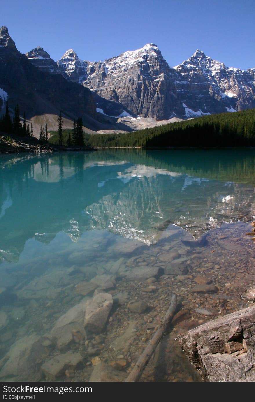 Clear blue water of lake morraine in canada with majestic mountain backdrop. Clear blue water of lake morraine in canada with majestic mountain backdrop