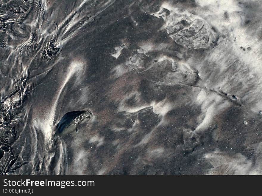 Black sand on a beach, great for background or texture