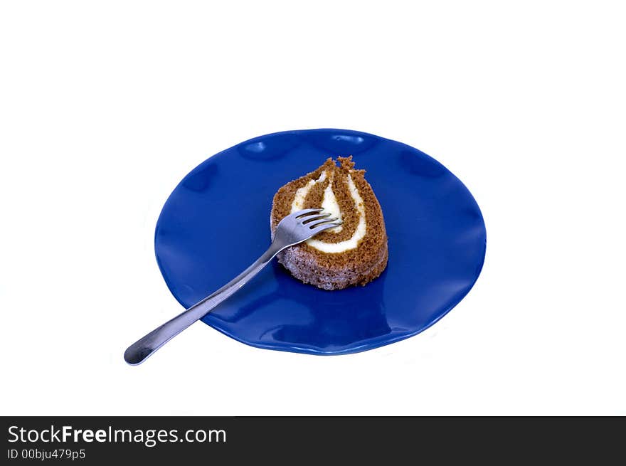 Pumpkin roll on blue plate with fork