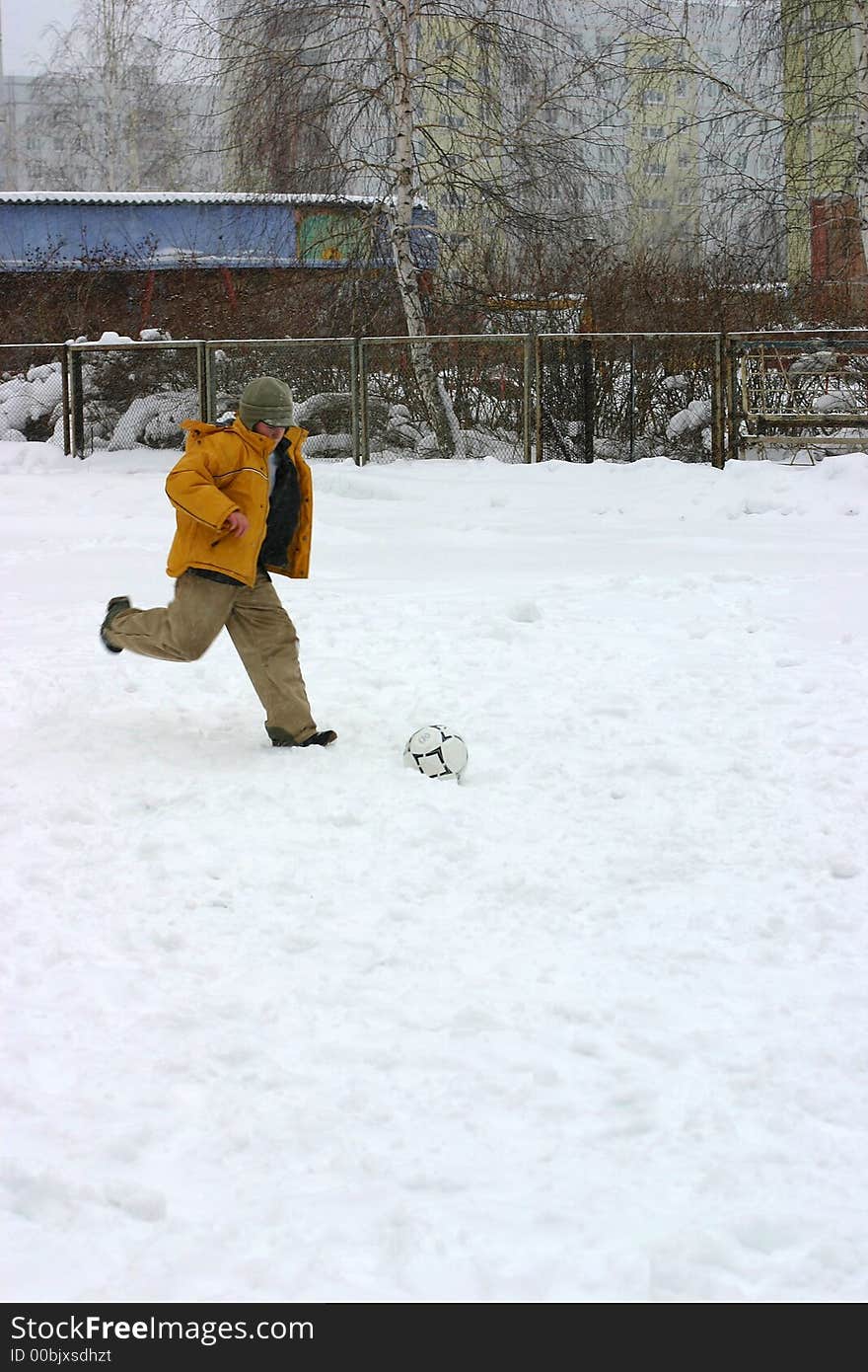 The child playing football. Winter. The child playing football. Winter