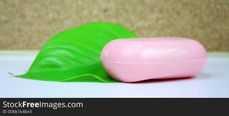 A green leaf with pink soap - wellness - spa. A green leaf with pink soap - wellness - spa