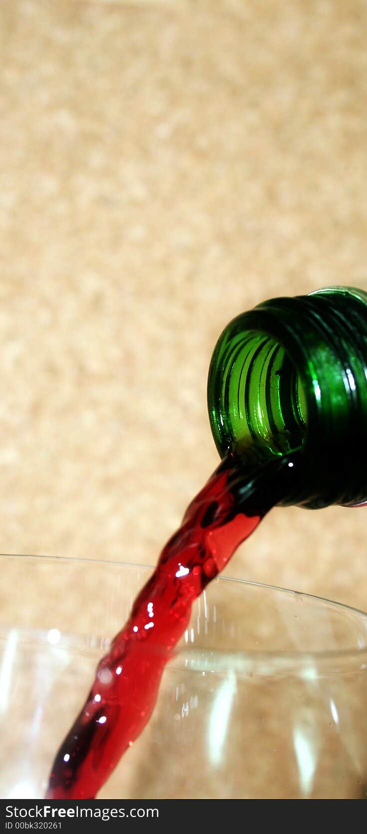 Red wine pouring down from a wine bottle