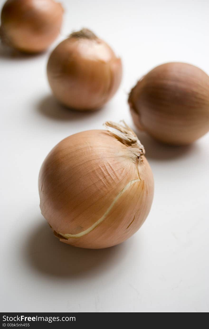 Four onions on white background