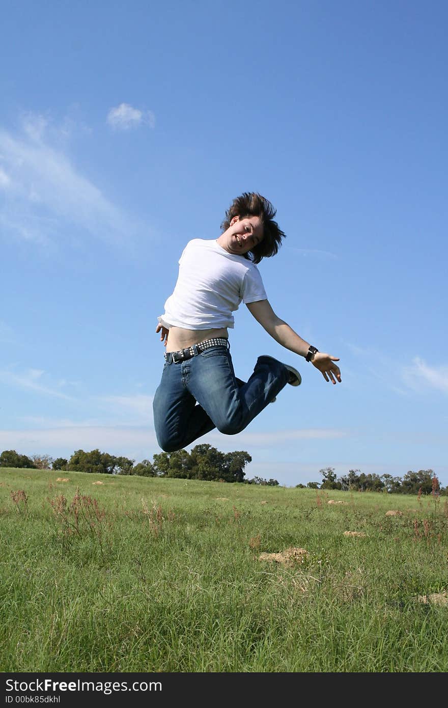 Photo of a young man in a field ~Happy Hill Road~. Photo of a young man in a field ~Happy Hill Road~