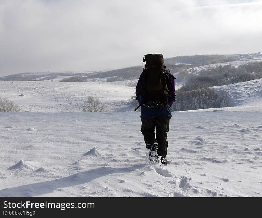 Men is walking in snows of Carabie's plateau in Crimean Mountains (Ukraine). Men is walking in snows of Carabie's plateau in Crimean Mountains (Ukraine)
