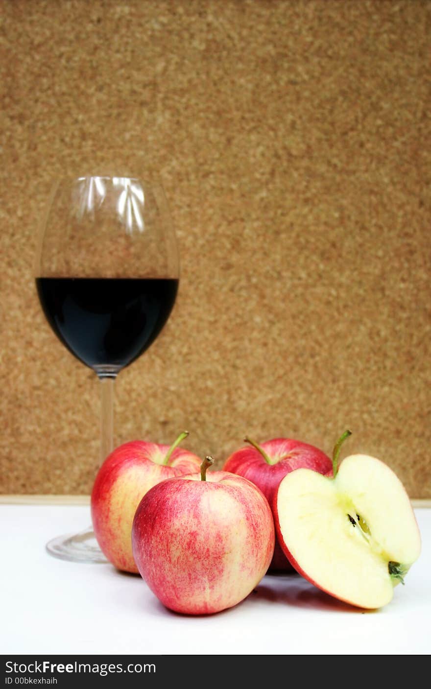 Red wine in a glass with four apple. Red wine in a glass with four apple