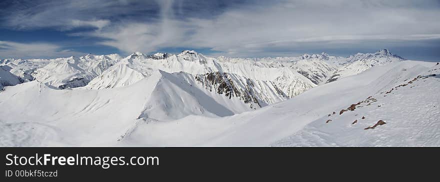 Mountain peaks in Georgia, near Gudauri ski resort.  Panoramic view is from Sutzelly Mountain. Mountain peaks in Georgia, near Gudauri ski resort.  Panoramic view is from Sutzelly Mountain.