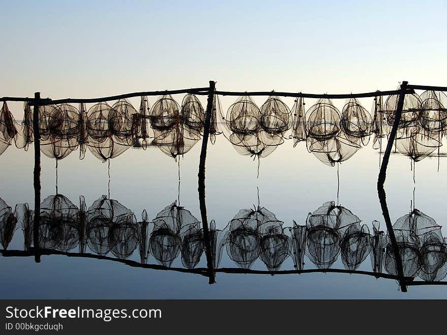 Fishing traps against lovely reflection at sunset. Fishing traps against lovely reflection at sunset