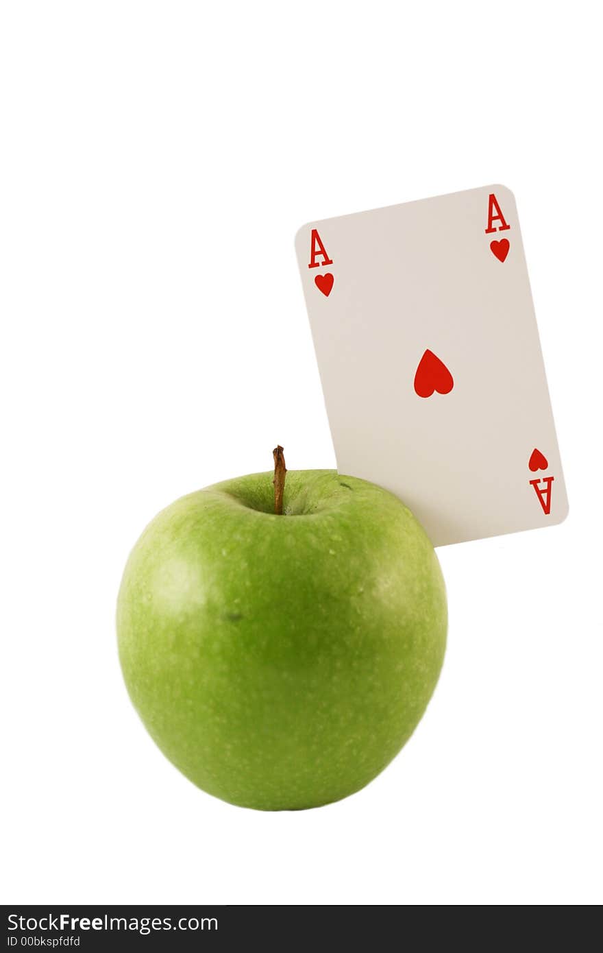 Green apple with the ace of hearts on a white background