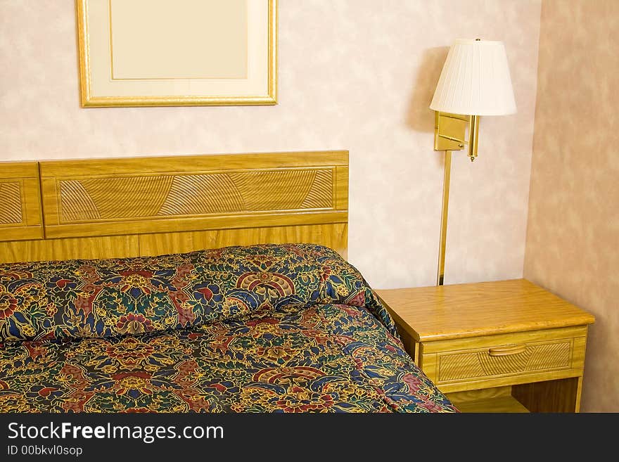 Hotel room showing the bed night stand and lamp