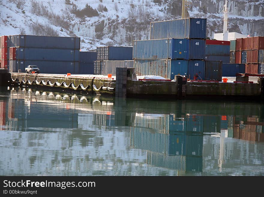 Shipping containers piled on a winter shipping dock. Shipping containers piled on a winter shipping dock.