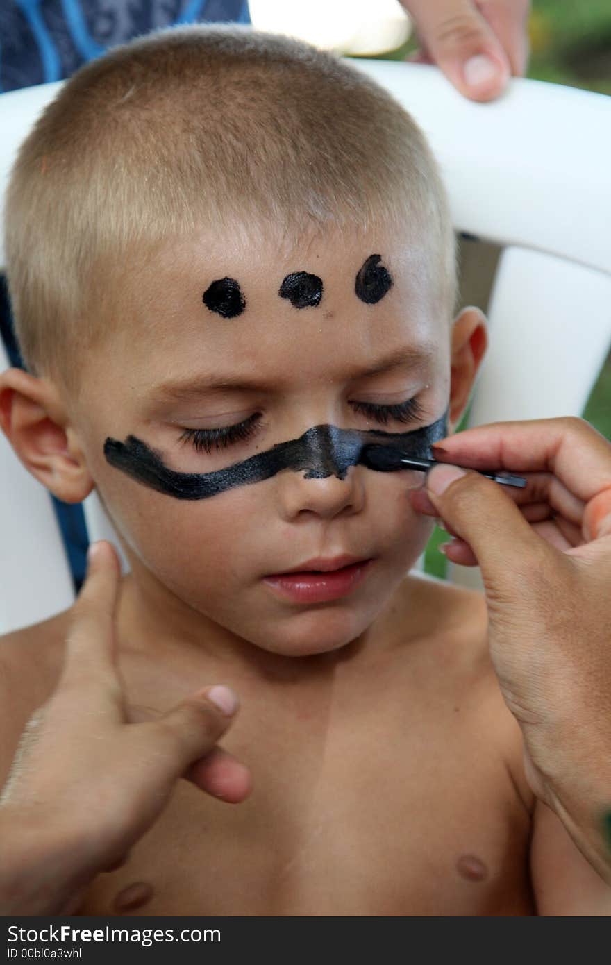 Boy being applied make up. Boy being applied make up