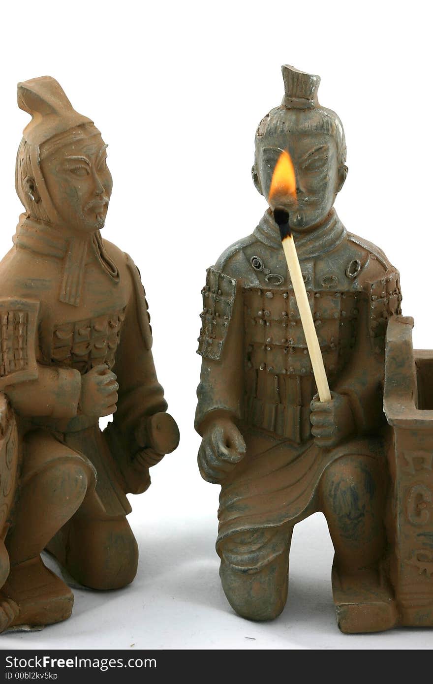 Two chinese warriors in traditional ancient uniforms holding torch and watching flame. Two chinese warriors in traditional ancient uniforms holding torch and watching flame