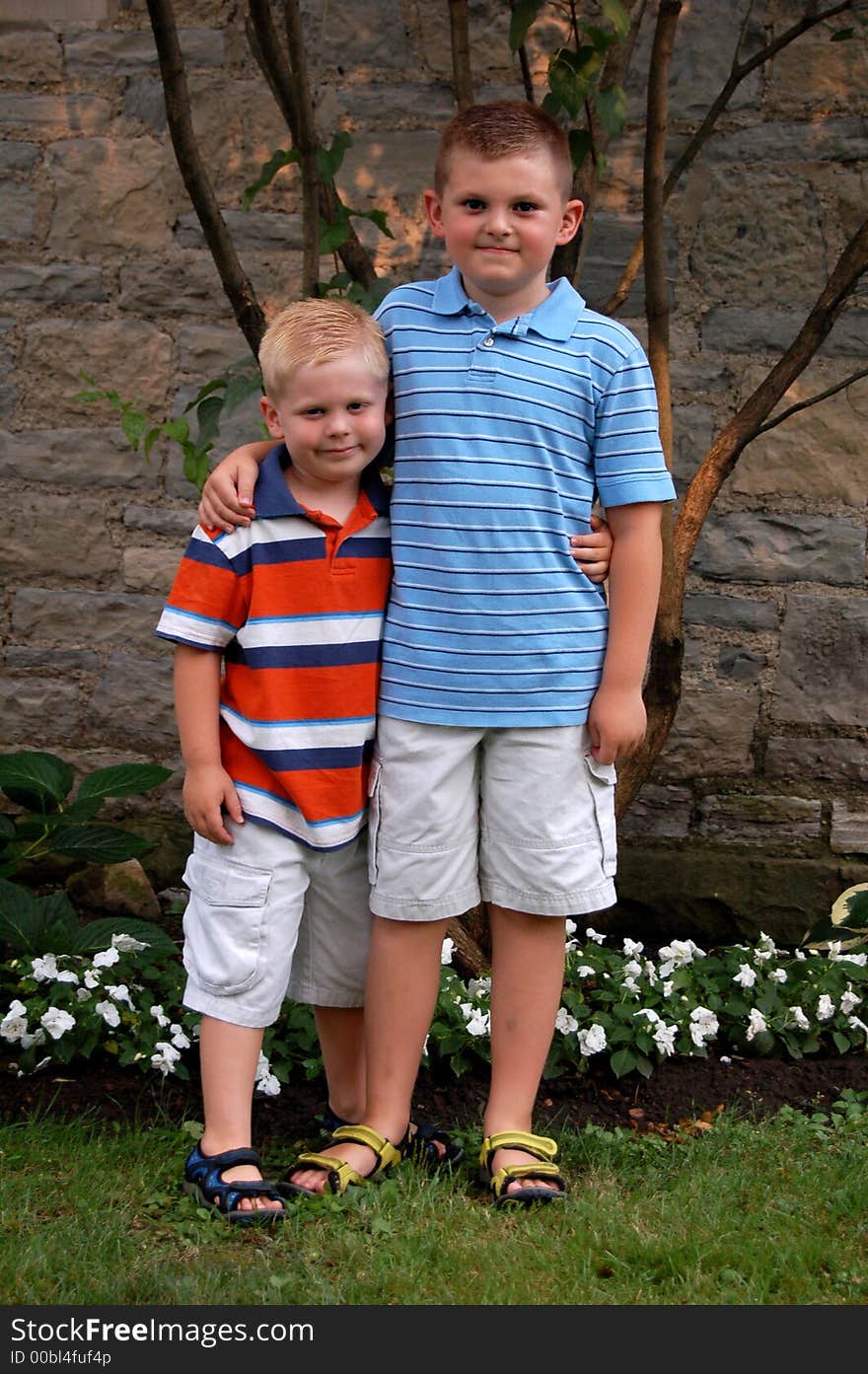 Two brothers standing together in front of a church.