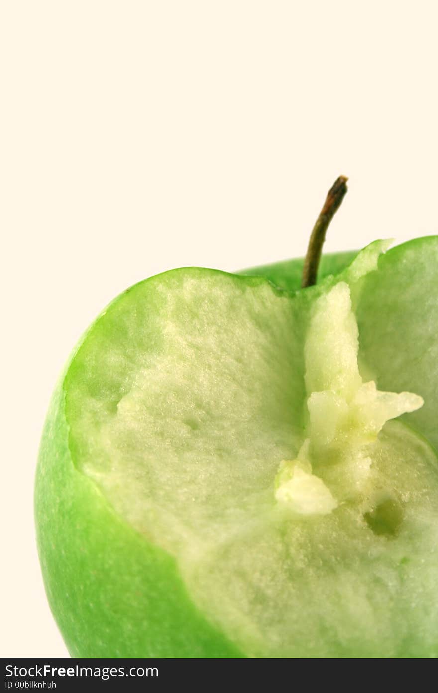 Bited green apple on a white background