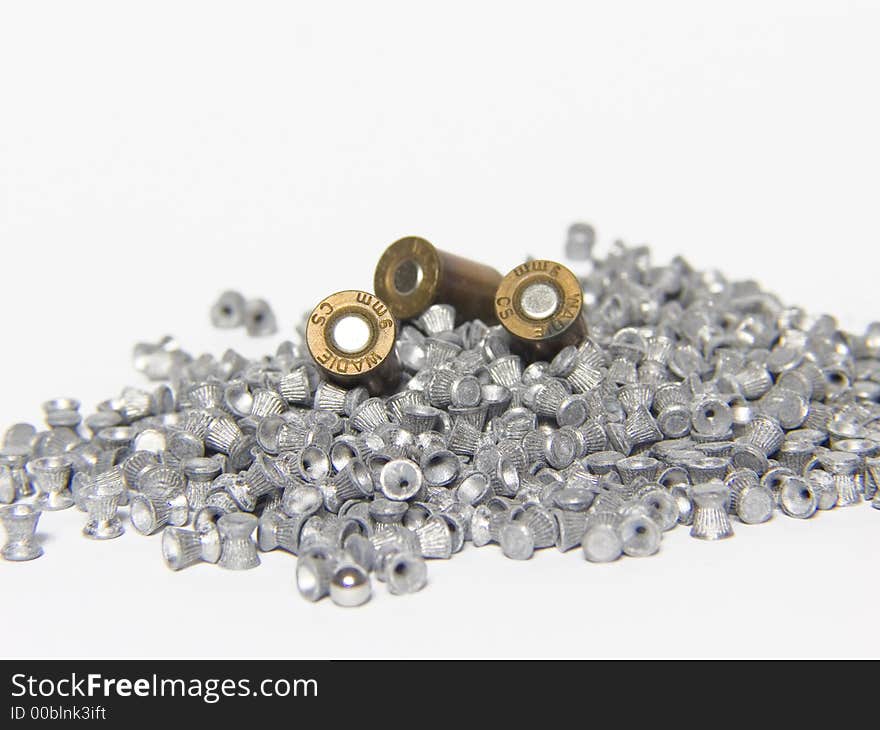 Macro of pneumatic and 9mm bullets on white background