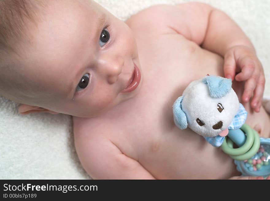 Image of baby holding a rattle. Image of baby holding a rattle