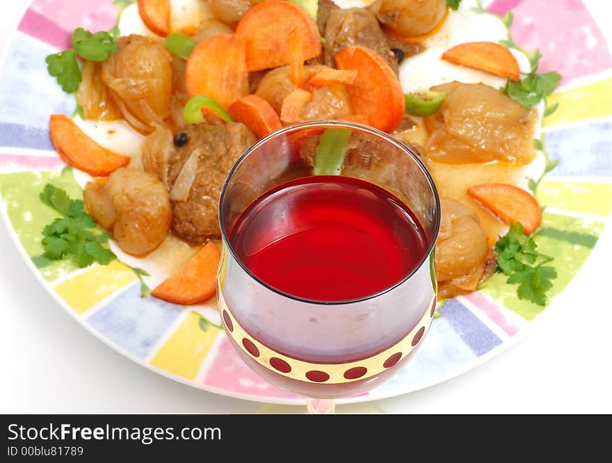 Meat dish with a red glass of wine (traditional   Greek receipe)