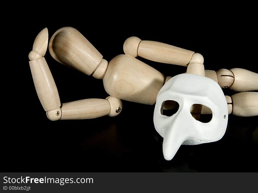 A wooden mannequin with some venetian carnival masks