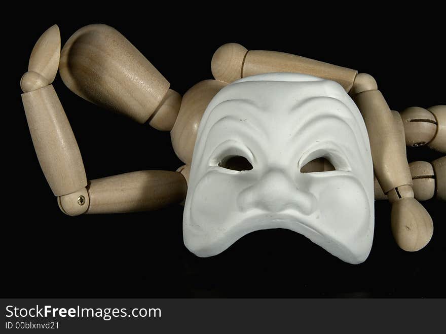 A wooden mannequin with some venetian carnival masks