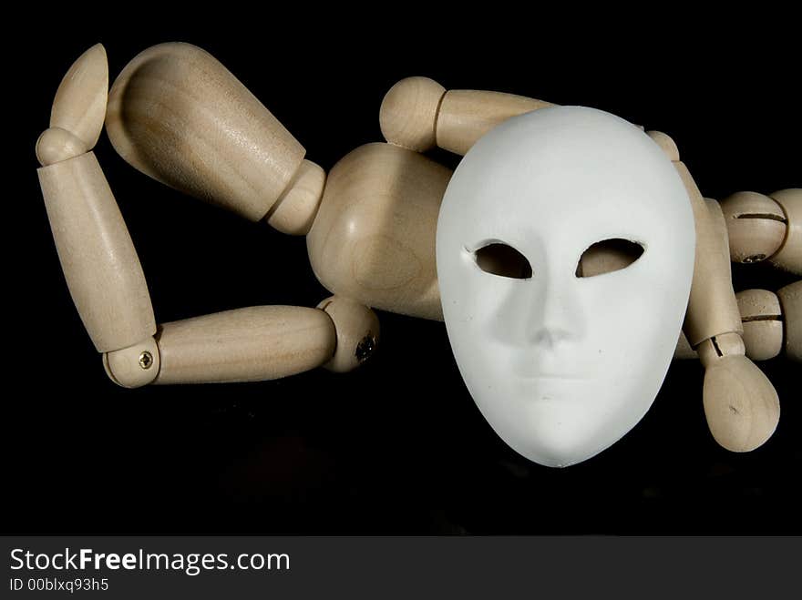 A wooden mannequin with some venetian carnival masks