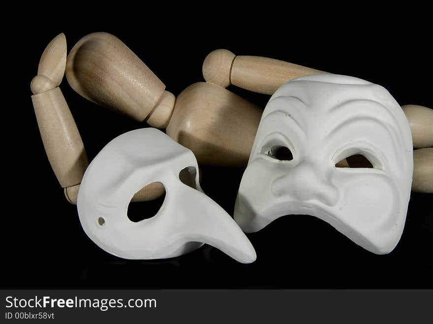 A wooden mannequin with some venetian carnival masks