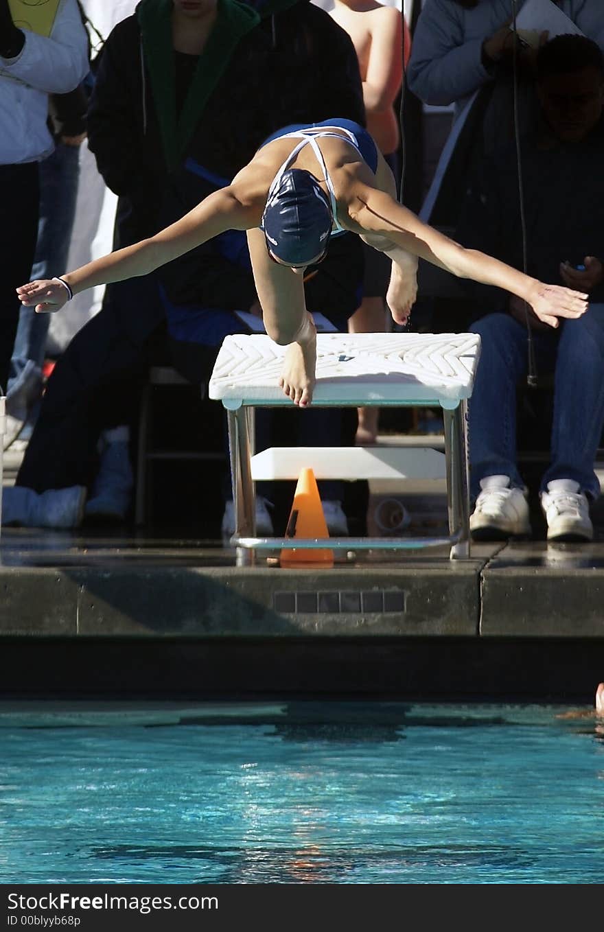 Young woman diving off the block. Young woman diving off the block.