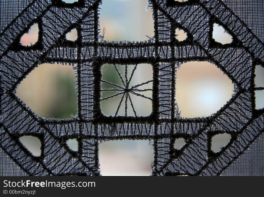 A detail of an emroidery on a curtain. A detail of an emroidery on a curtain