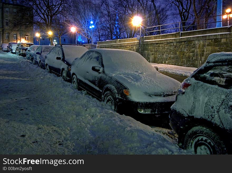 Covered with snow cars parked at roadside. Covered with snow cars parked at roadside