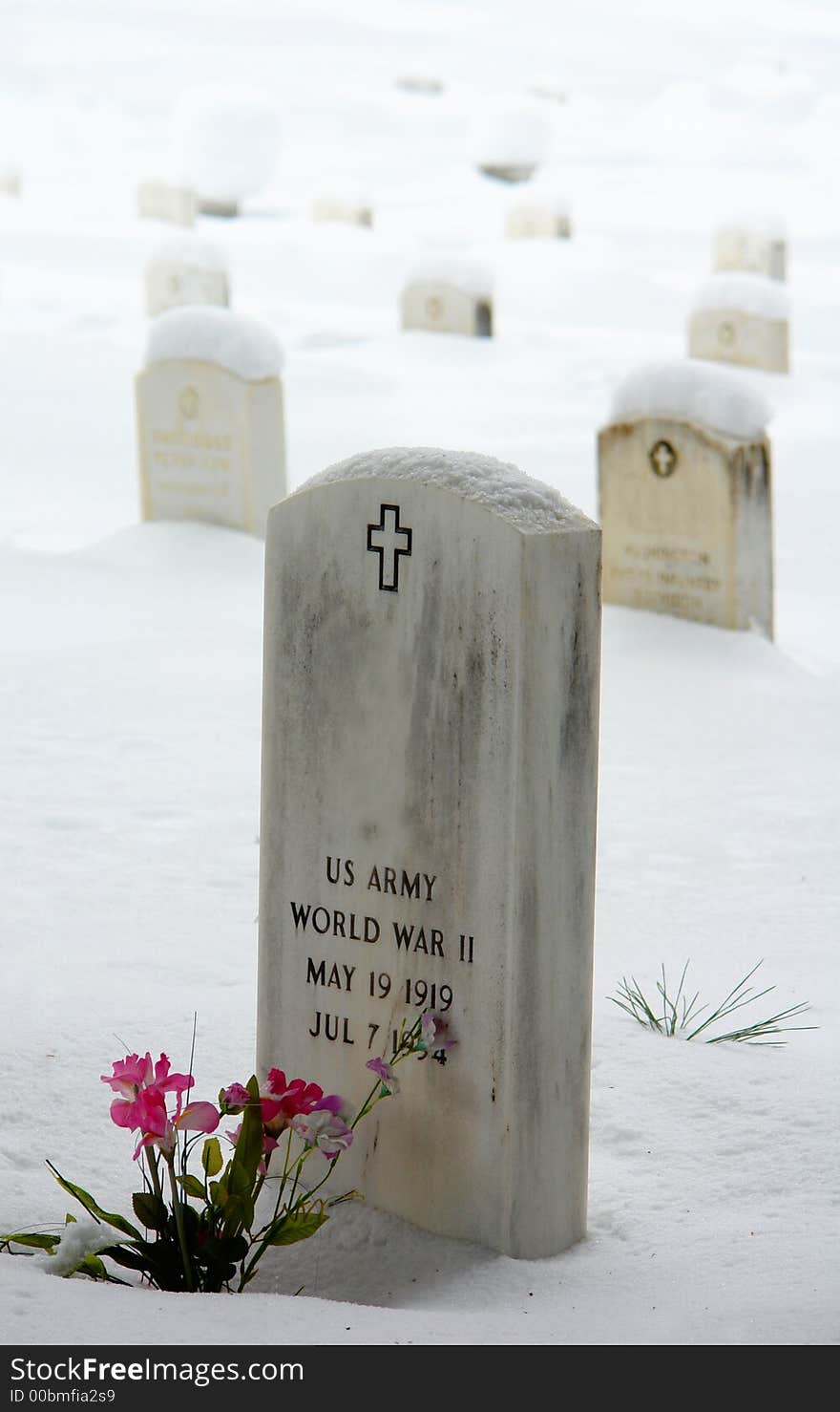 Soldier lies in a cemetery covered in snow. Soldier lies in a cemetery covered in snow