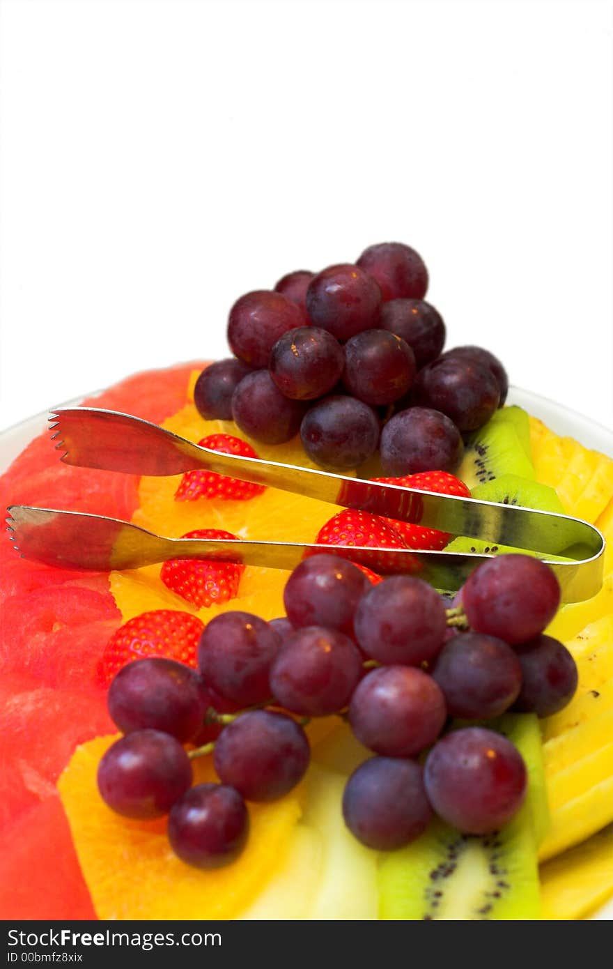 Fruits on the plate vertical on white background