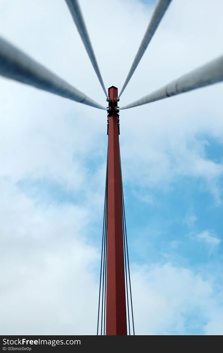 A suspended footbridge on a cloudy blue sky. A suspended footbridge on a cloudy blue sky