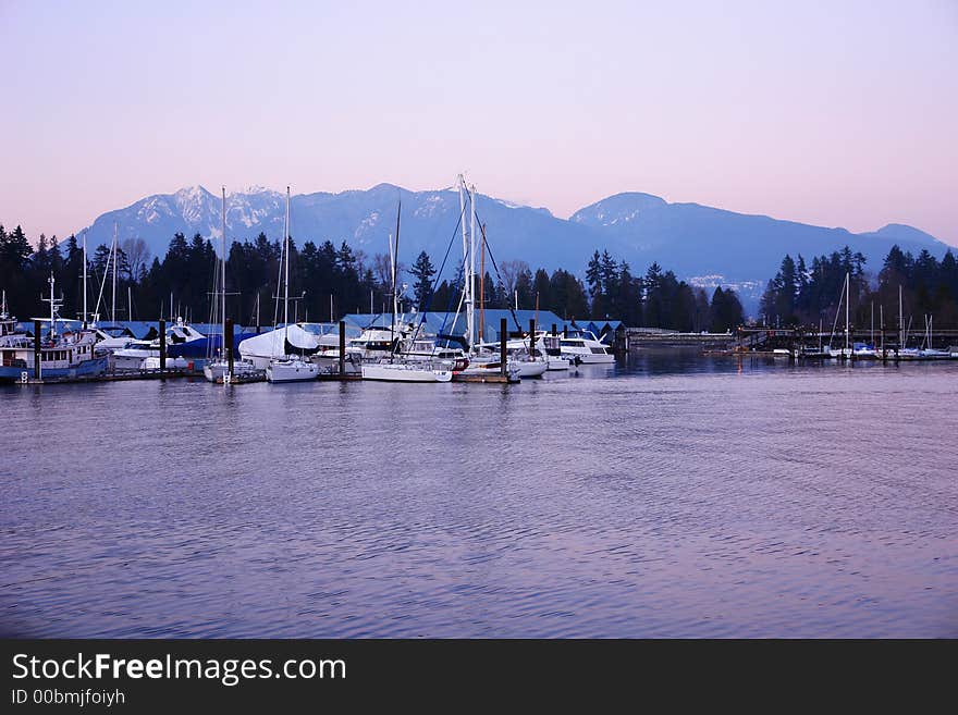 Sailboats moored with mountains in the background. Sailboats moored with mountains in the background