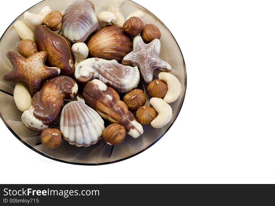 Dessert chocolate truffle candies shaped like seashells with hazel nuts, almonds and cashew nuts. Dessert chocolate truffle candies shaped like seashells with hazel nuts, almonds and cashew nuts