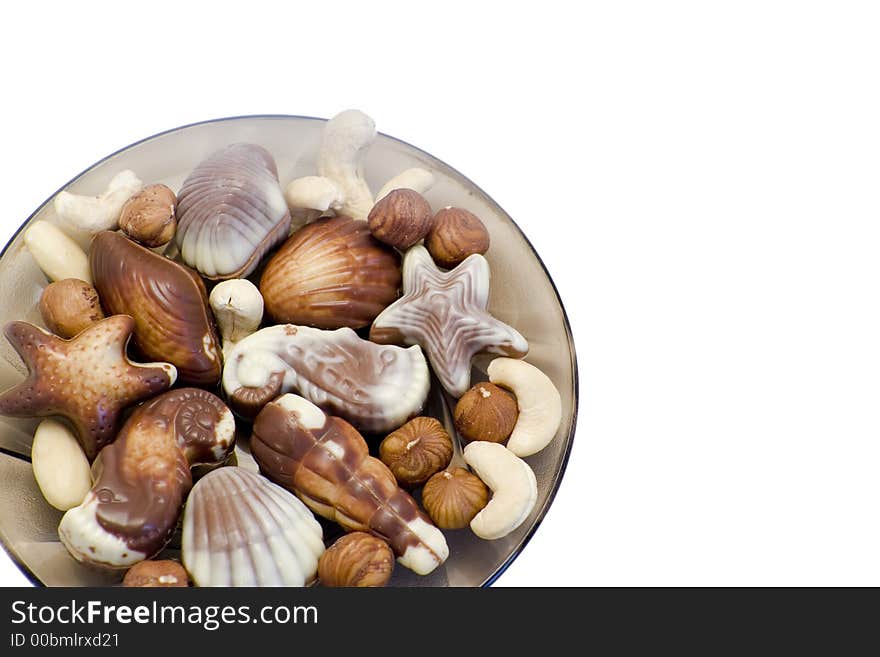 Dessert chocolate truffle candies shaped like seashells with hazel nuts, almonds and cashew nuts. Dessert chocolate truffle candies shaped like seashells with hazel nuts, almonds and cashew nuts