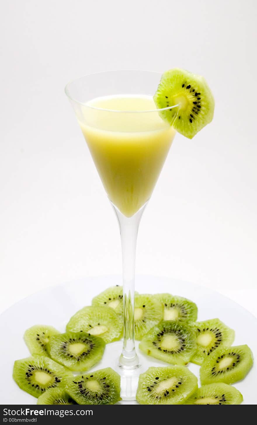 Healthy glass of juice with green kiwi slices around over white background. Healthy glass of juice with green kiwi slices around over white background