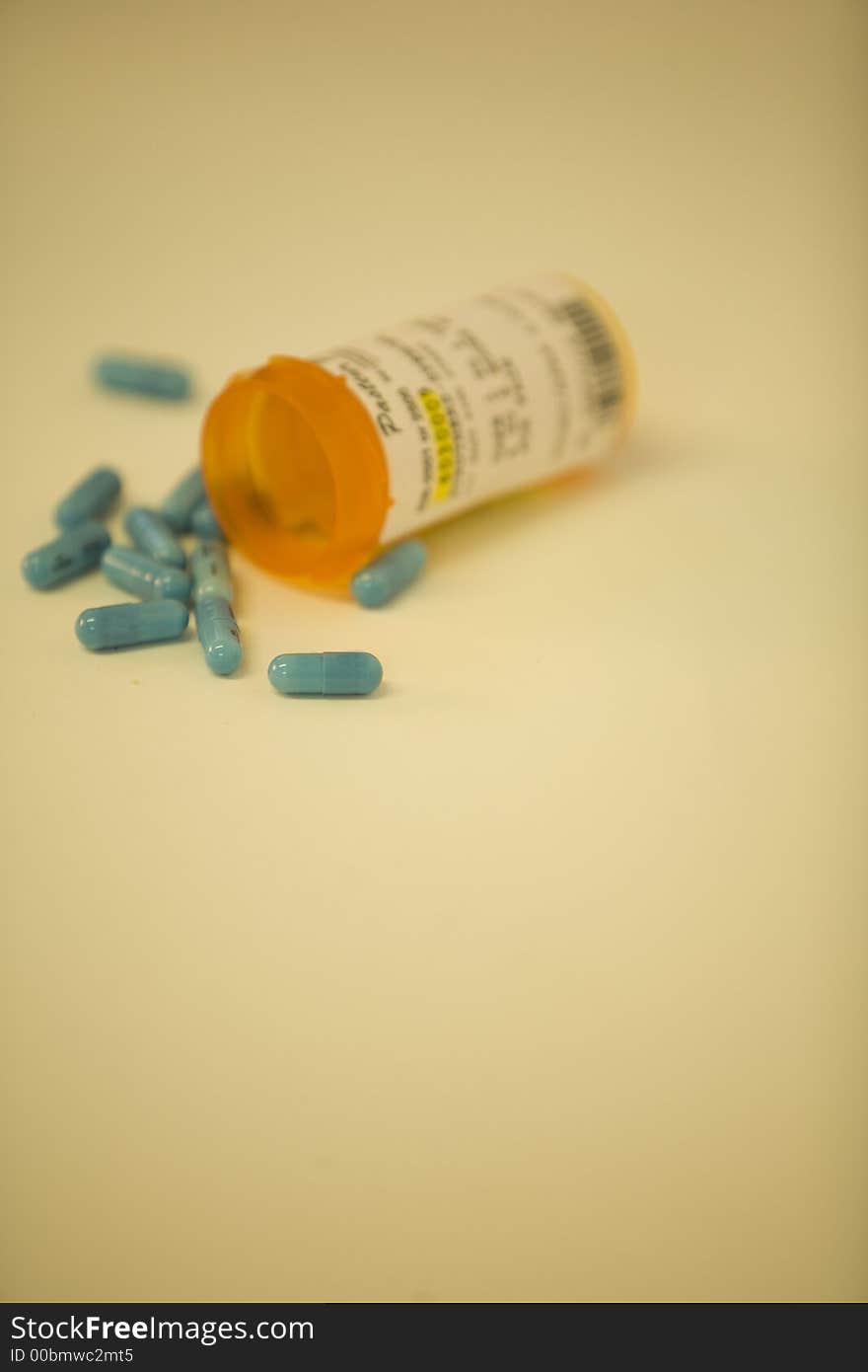 Bottle of medicine with copy space and shallow depth of field in warm tones. Bottle of medicine with copy space and shallow depth of field in warm tones