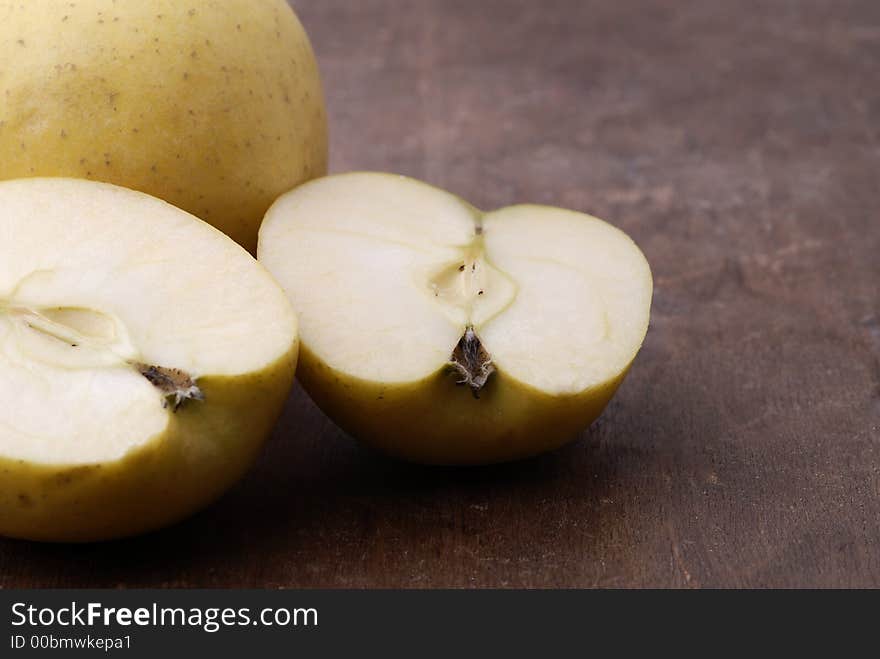 Apples on an aged wooden table/cutting board. Apples on an aged wooden table/cutting board.