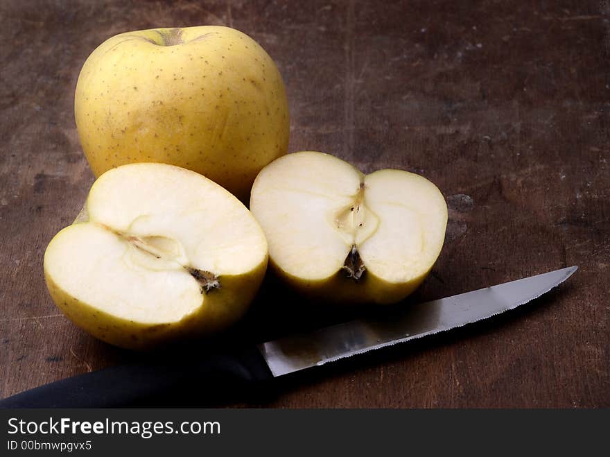 Apples on an aged wooden table/cutting board. Apples on an aged wooden table/cutting board.