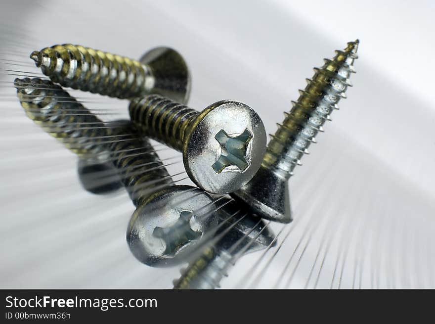 Three screws on metallic background close up shoot