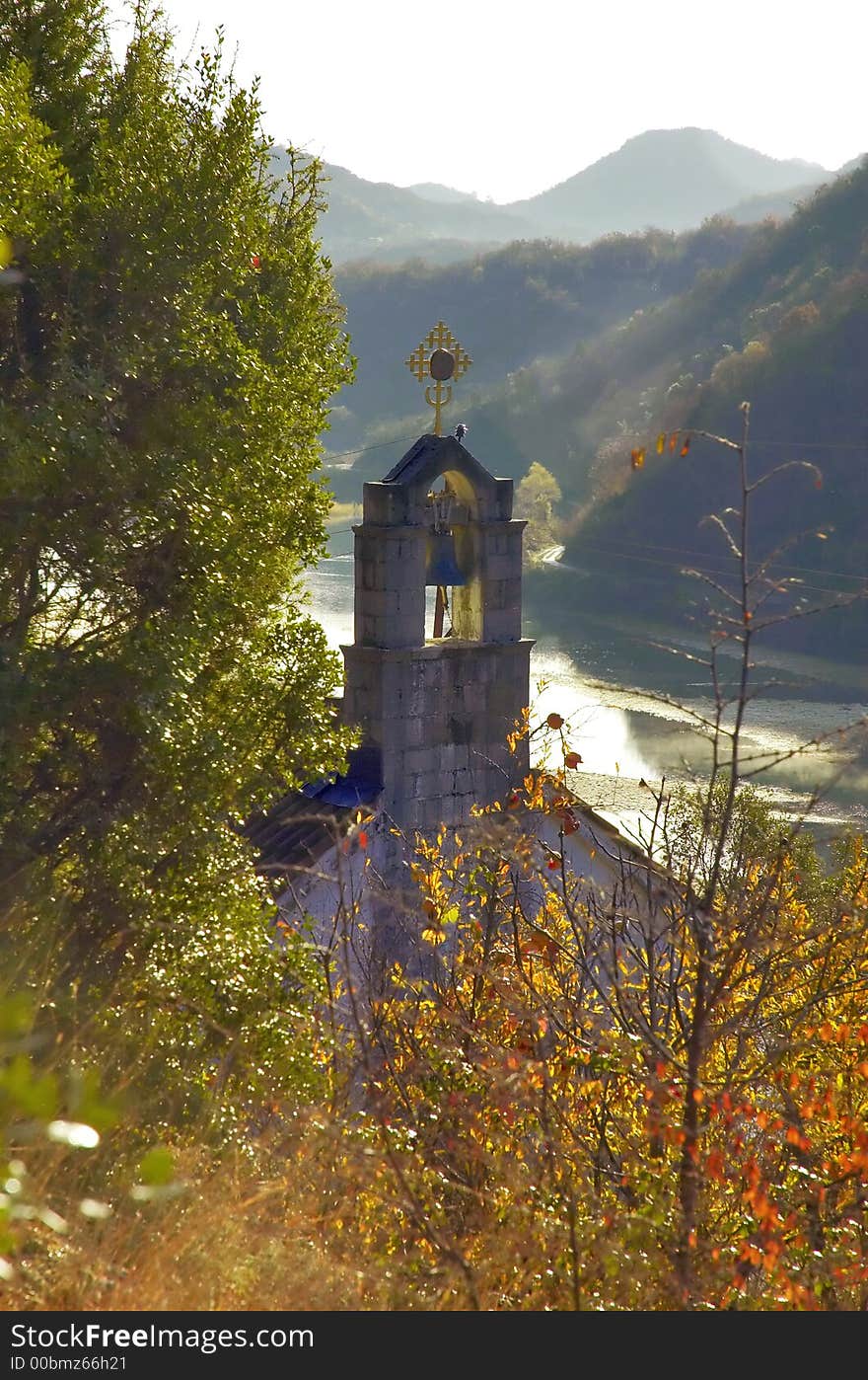 Small orthodox church with lake in background. Dreamy composition.