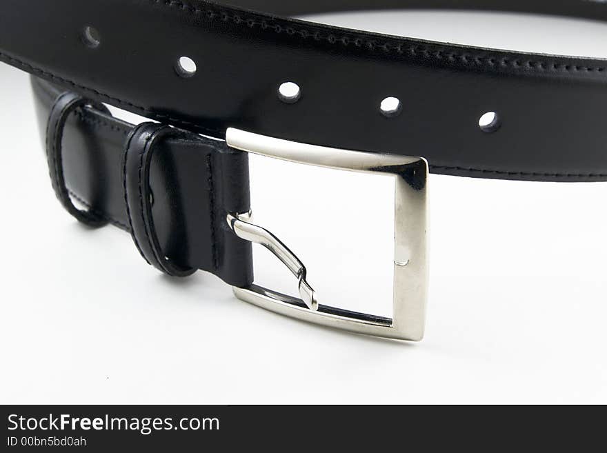 Black leather belt with buckle unfastened on white background. Black leather belt with buckle unfastened on white background