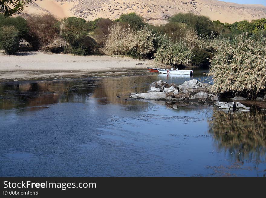 A beautiful scene of the meeting between the desert and the green plants on one of the many islands located within river Nile in Aswan of upper Egypt. A beautiful scene of the meeting between the desert and the green plants on one of the many islands located within river Nile in Aswan of upper Egypt.