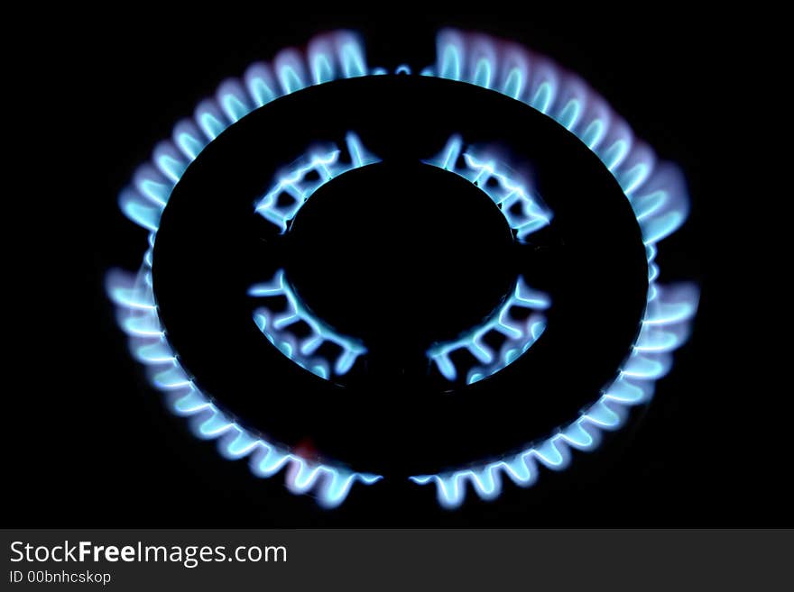 Blue flames form a gas fire in a stove. Blue flames form a gas fire in a stove