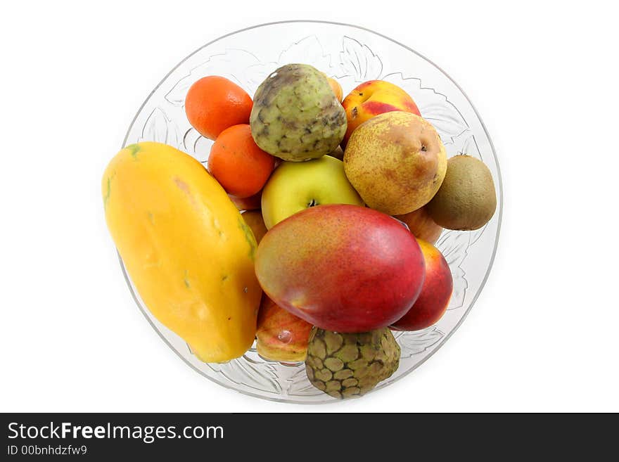 Glass bowl full of fruits isolated over white. Glass bowl full of fruits isolated over white