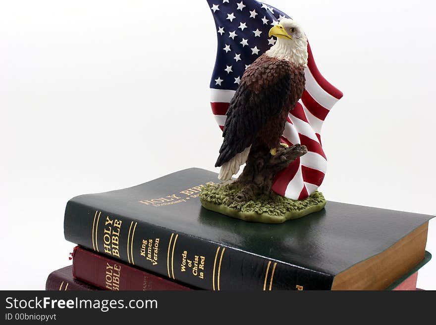 An eagle statuette on top of three bibles. An eagle statuette on top of three bibles